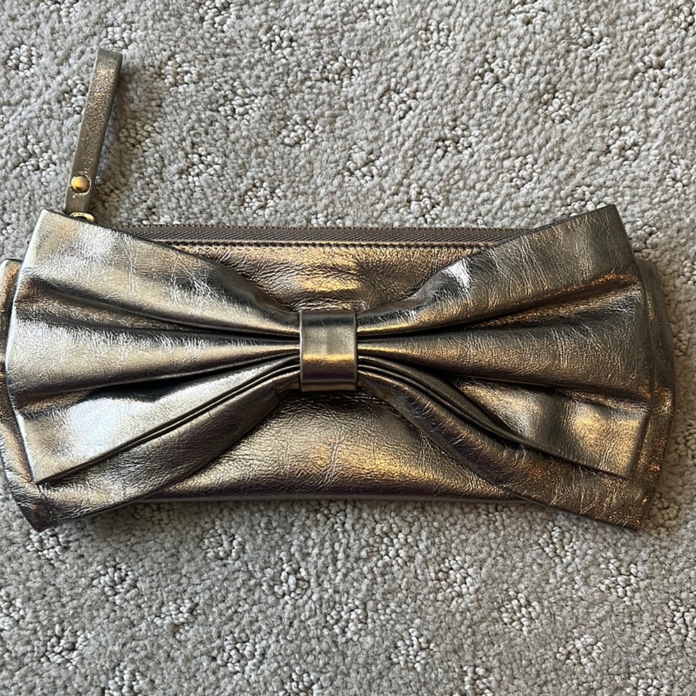Pretty metallic Kate Spade bow clutch